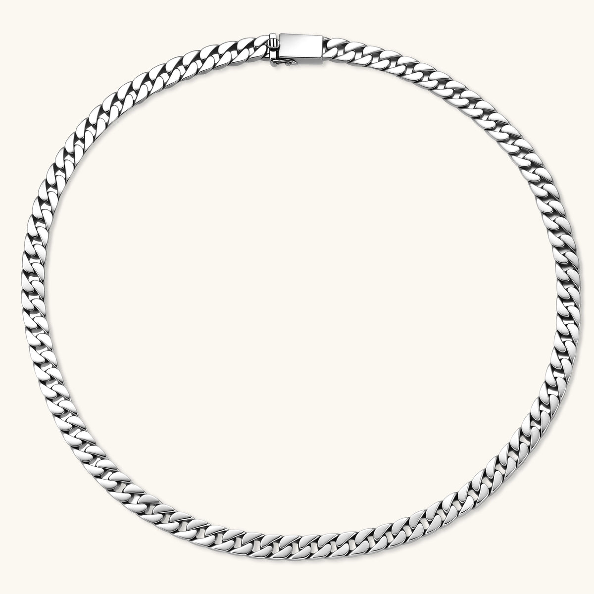 Polished 925 sterling silver Cuban link chain necklace, 550mm length, shown flat and draped on cream background.