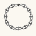 Sterling silver link bracelet with fleur-de-lis cross motifs, oxidized detailing, and hook clasp, 200mm length.