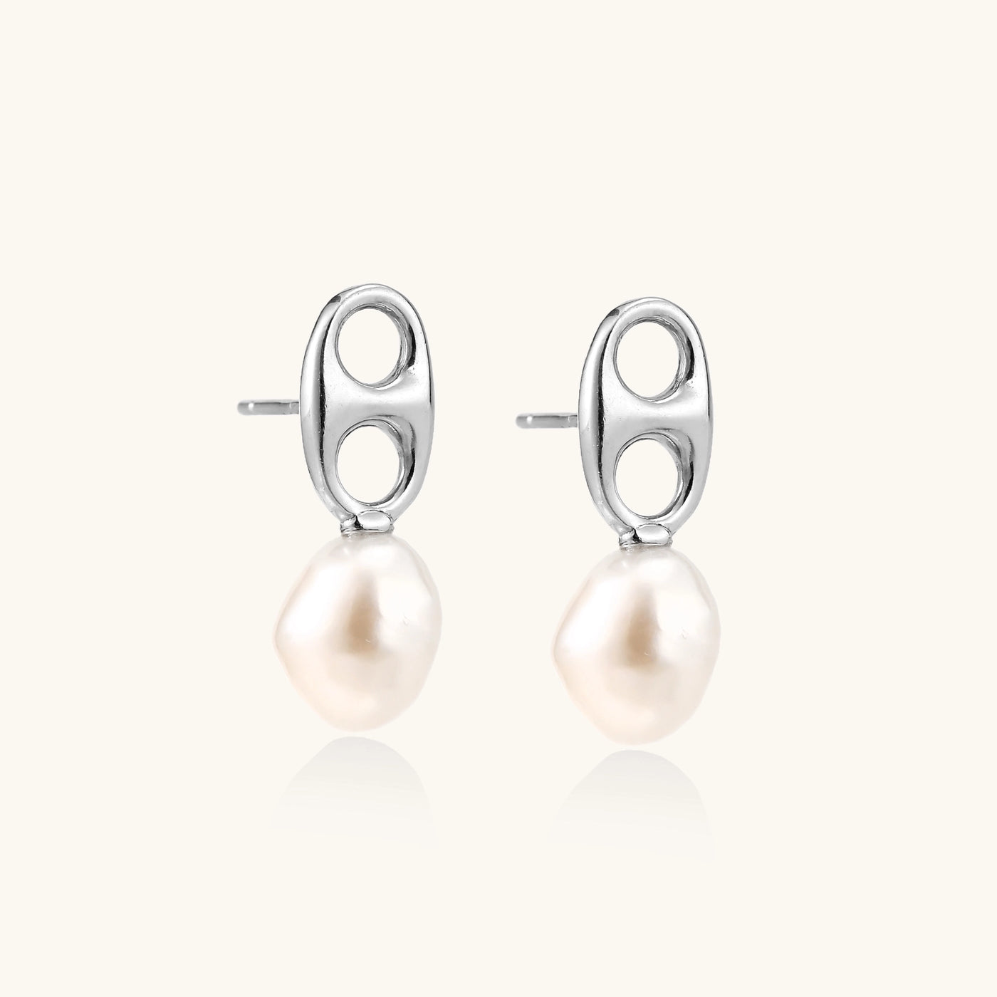 Sterling silver oval stud earrings with dual circular cutouts and suspended freshwater pearls on white background.
