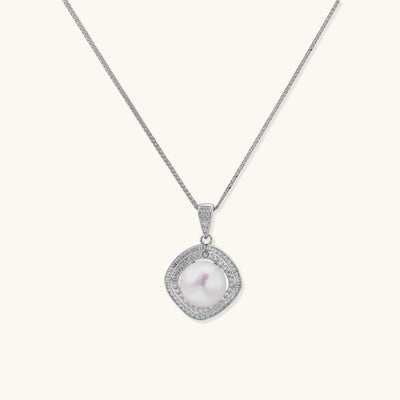 Sterling silver necklace with geometric halo setting surrounding a 10mm freshwater pearl on white background.
