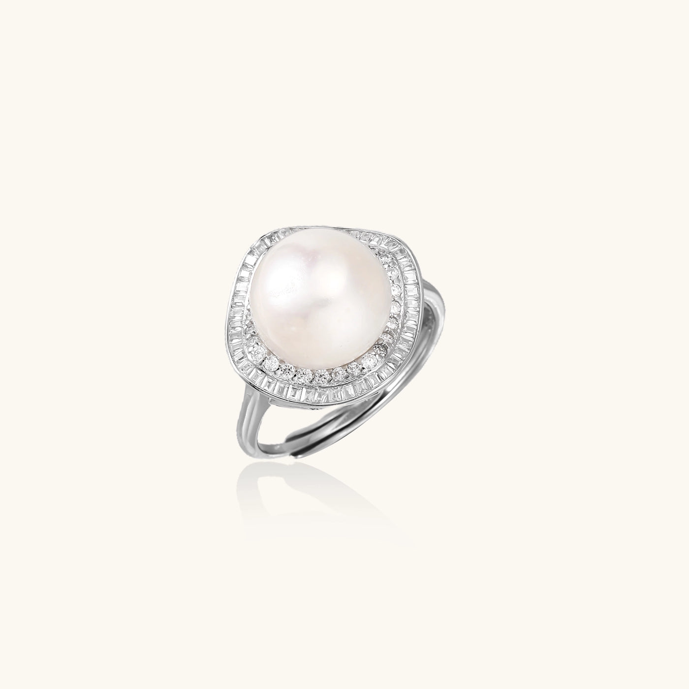 Sterling silver ring with 11mm freshwater pearl surrounded by double diamond halo on white background.