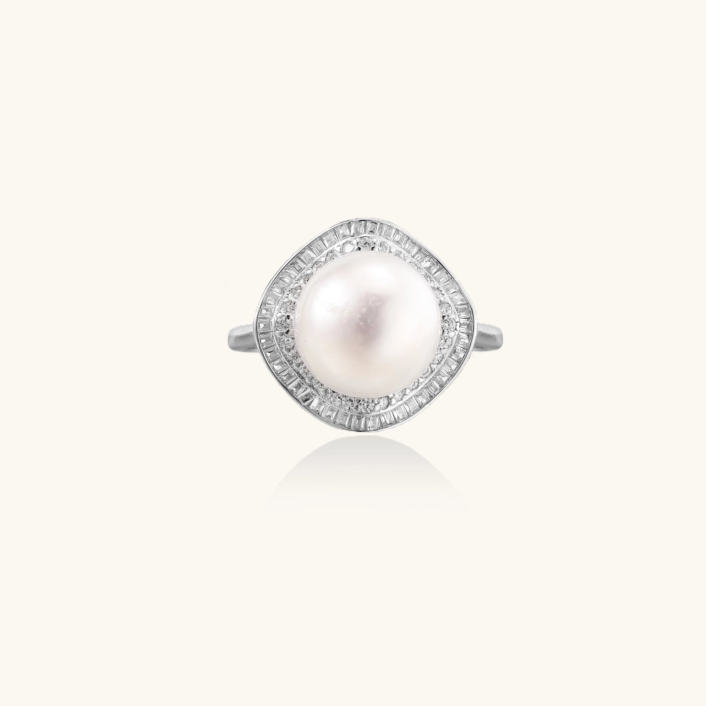 Sterling silver ring with 11mm freshwater pearl surrounded by double diamond halo on white background.
