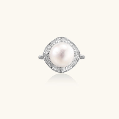 Sterling silver ring with 11mm freshwater pearl surrounded by double diamond halo on white background.