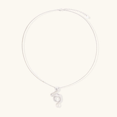 Sterling silver snake pendant necklace with zirconia crystals on adjustable chain against cream background