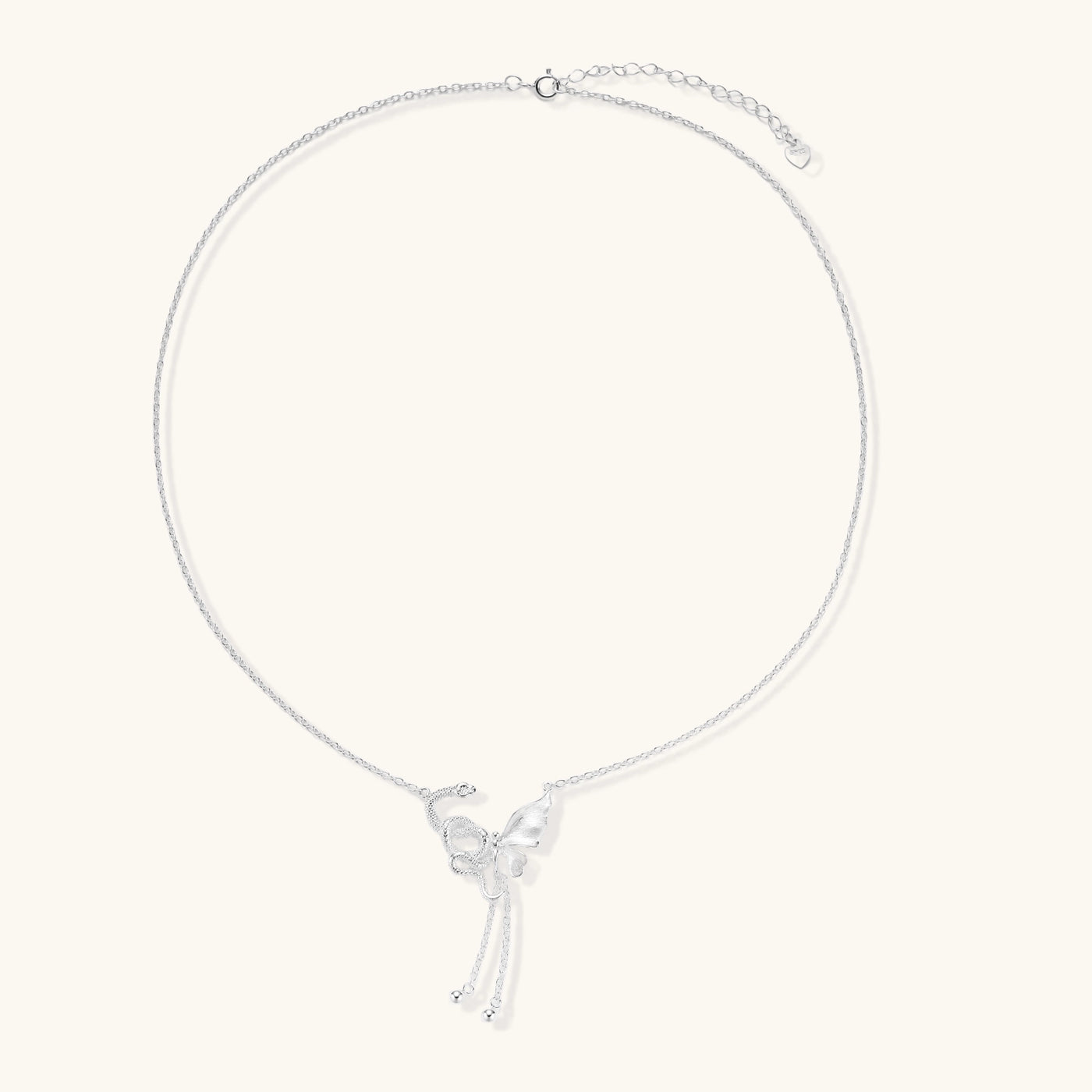 Delicate sterling silver butterfly pendant necklace with textured wing details and adjustable chain on white background