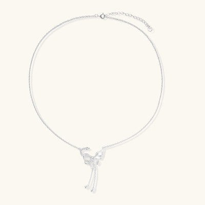 Delicate sterling silver butterfly pendant necklace with textured wing details and adjustable chain on white background