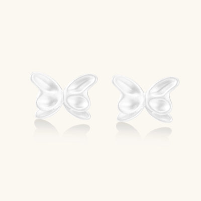 Delicate sterling silver butterfly stud earrings with intricate wing details on a neutral background.