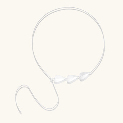 Delicate sterling silver necklace with brushed leaf pendants distributed along a fine chain on white background.