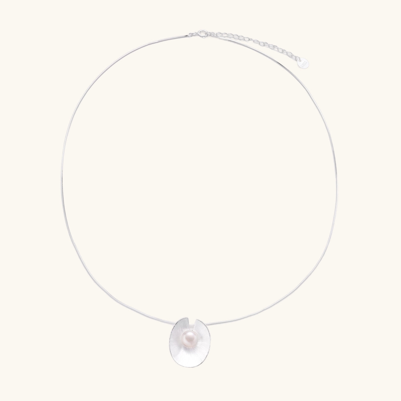 Delicate sterling silver necklace with oval iridescent pendant and central freshwater pearl on white background