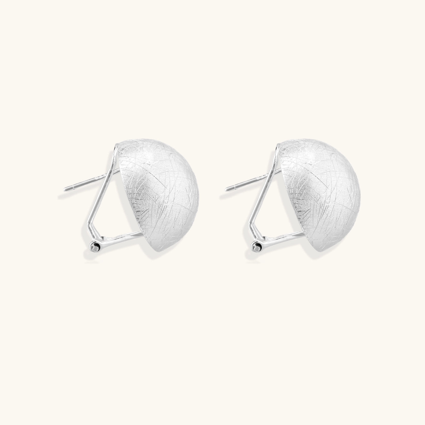 Brushed sterling silver dome-shaped stud earrings with textured surface and secure lever-back closure on white background.
