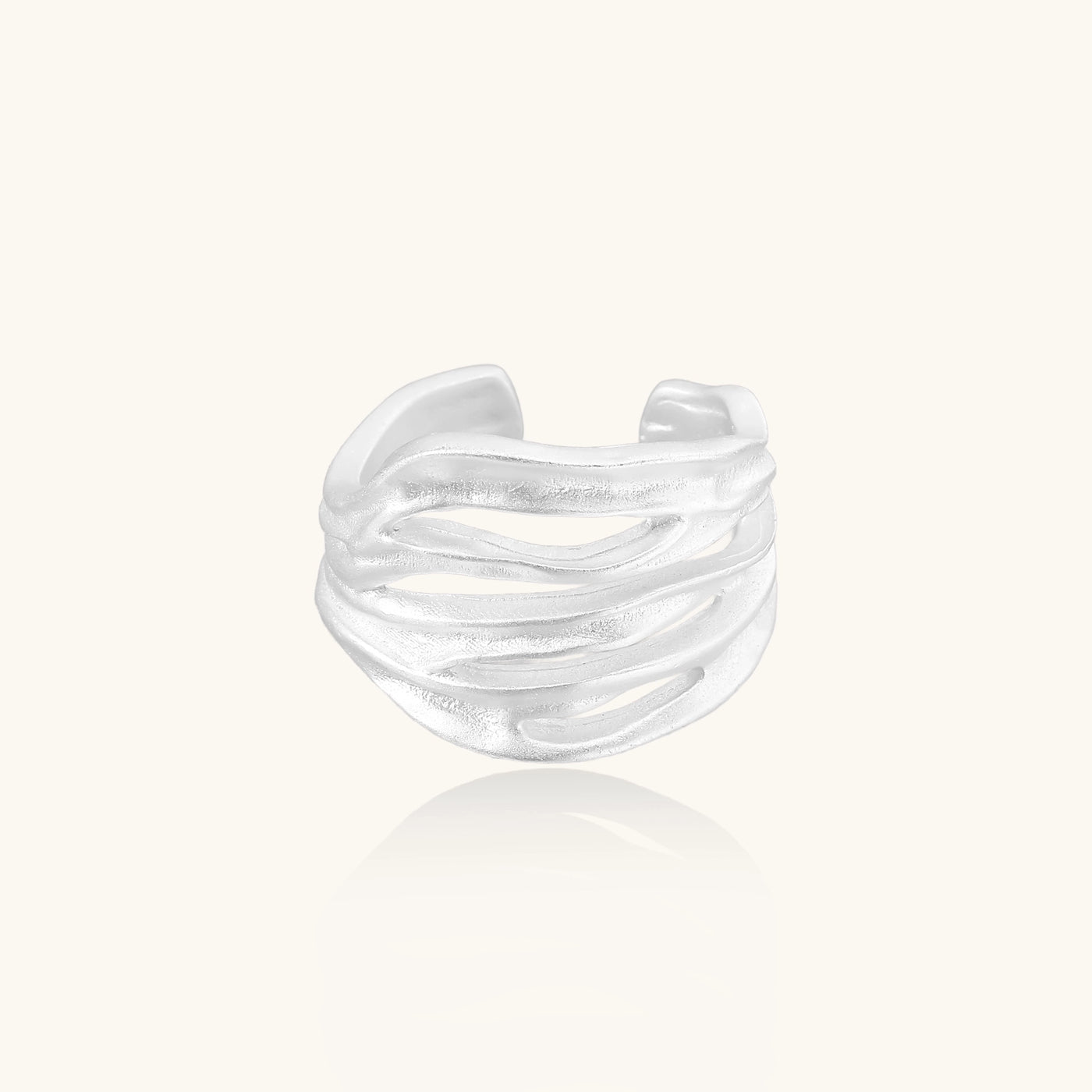 Wide sterling silver ring with flowing wave patterns and adjustable cuff design on white background.