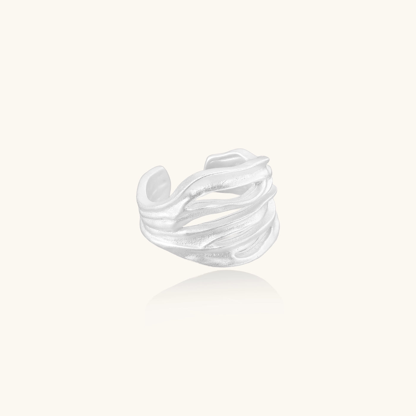 Wide sterling silver ring with flowing wave patterns and adjustable cuff design on white background.