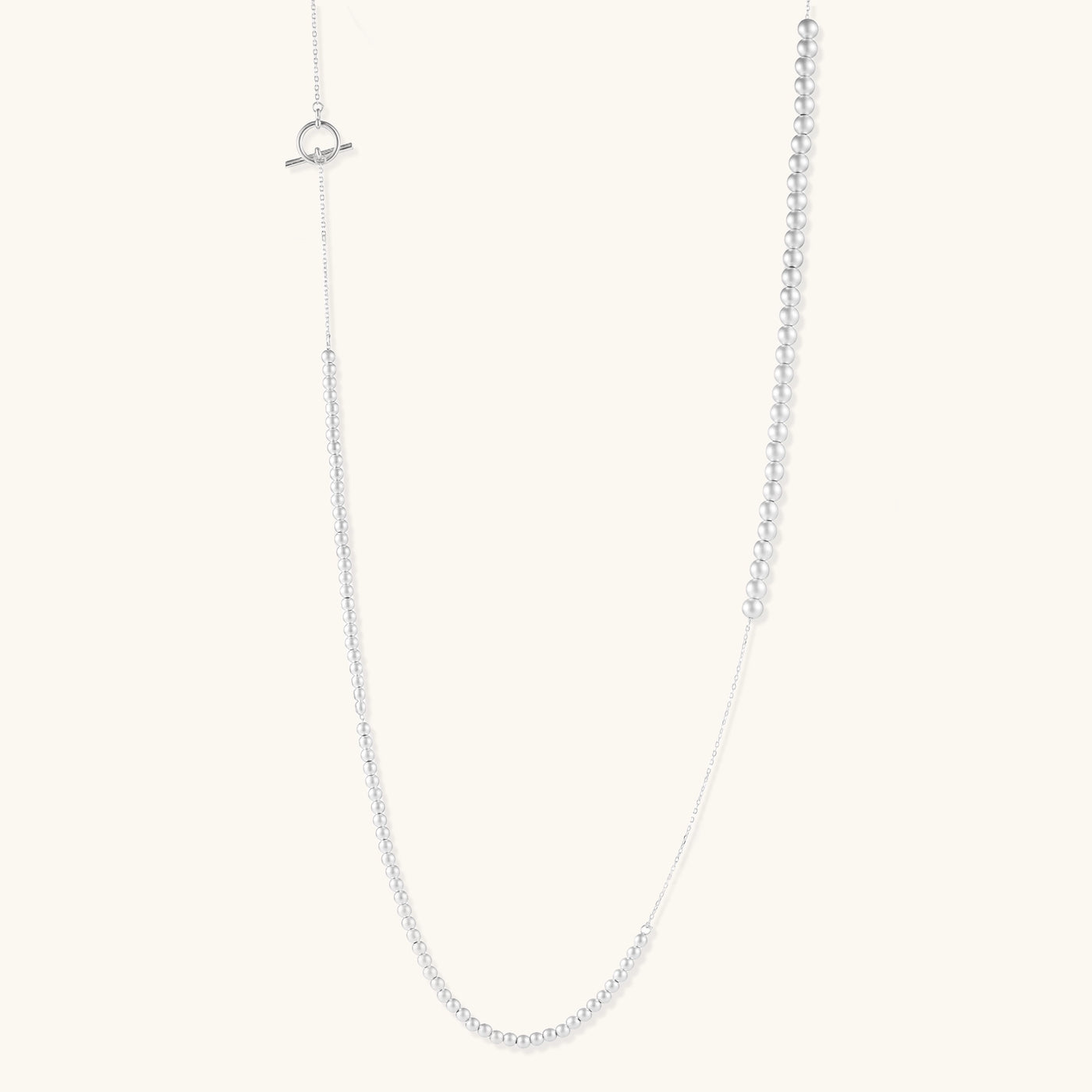 Sterling silver necklace with graduated pearl beads and delicate chain sections featuring a toggle clasp closure.