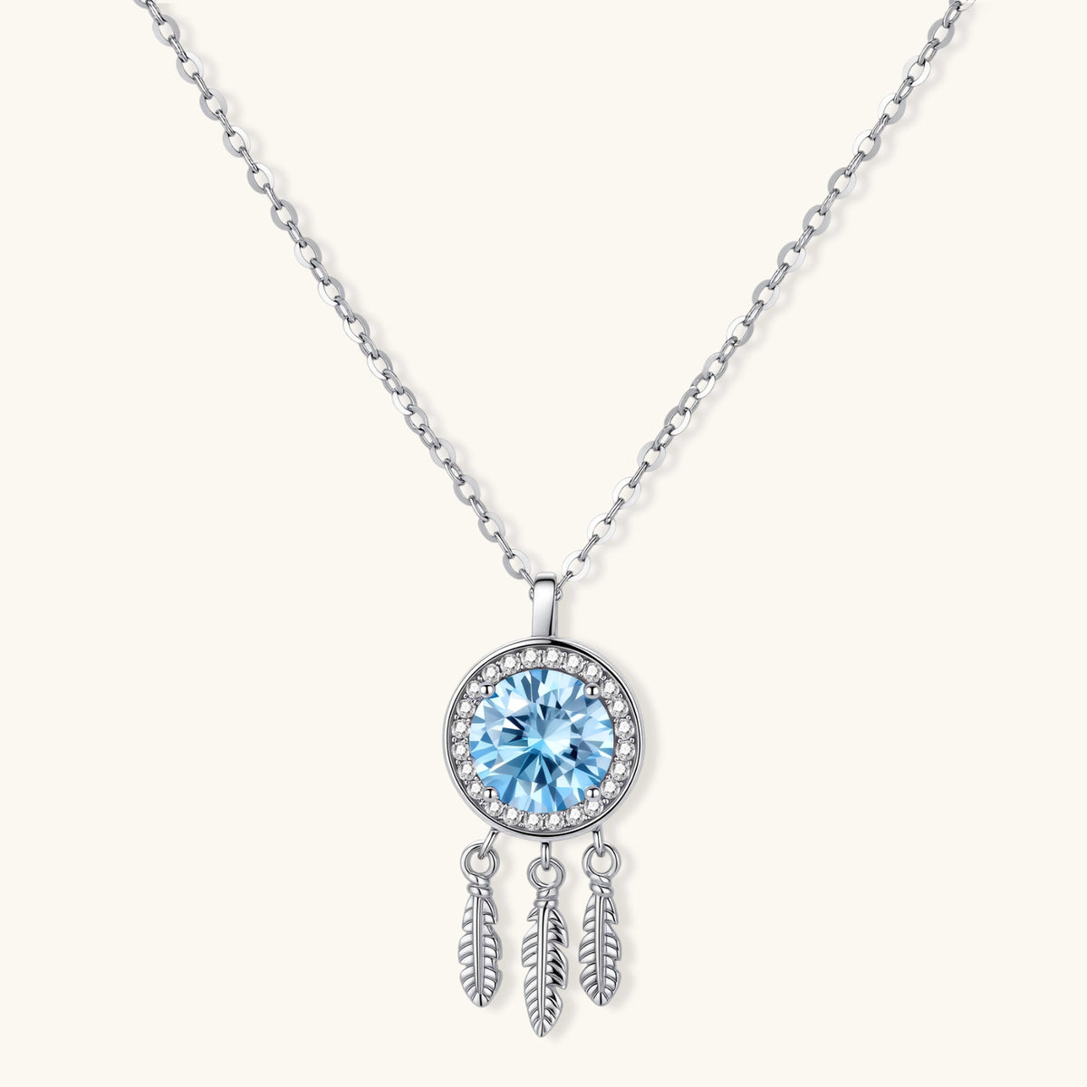 Sterling silver dreamcatcher pendant with blue moissanite center and three feather charms on adjustable chain.