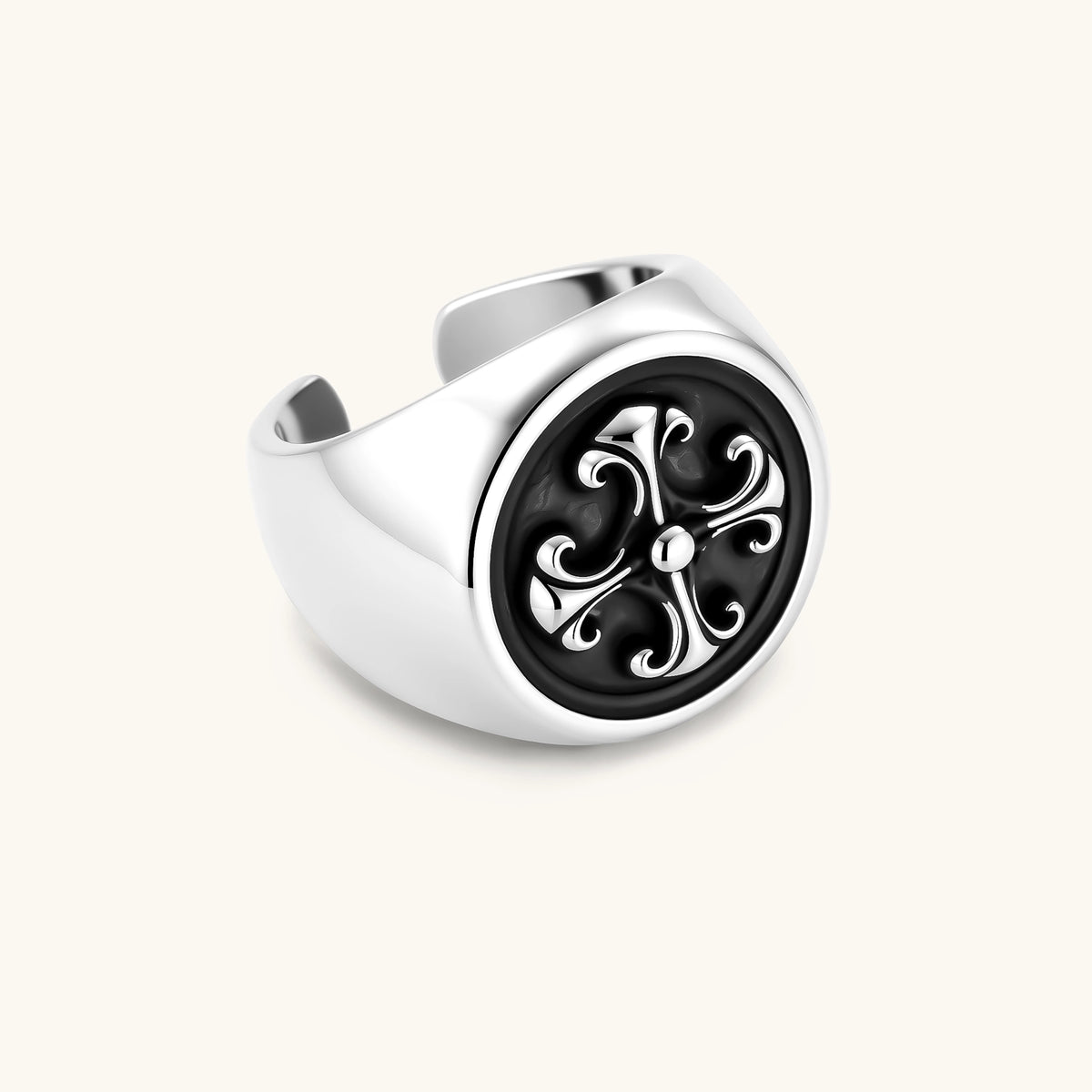925 sterling silver open signet ring with dark oxidized fleur-de-lis cross motif on circular face, adjustable cuff band.