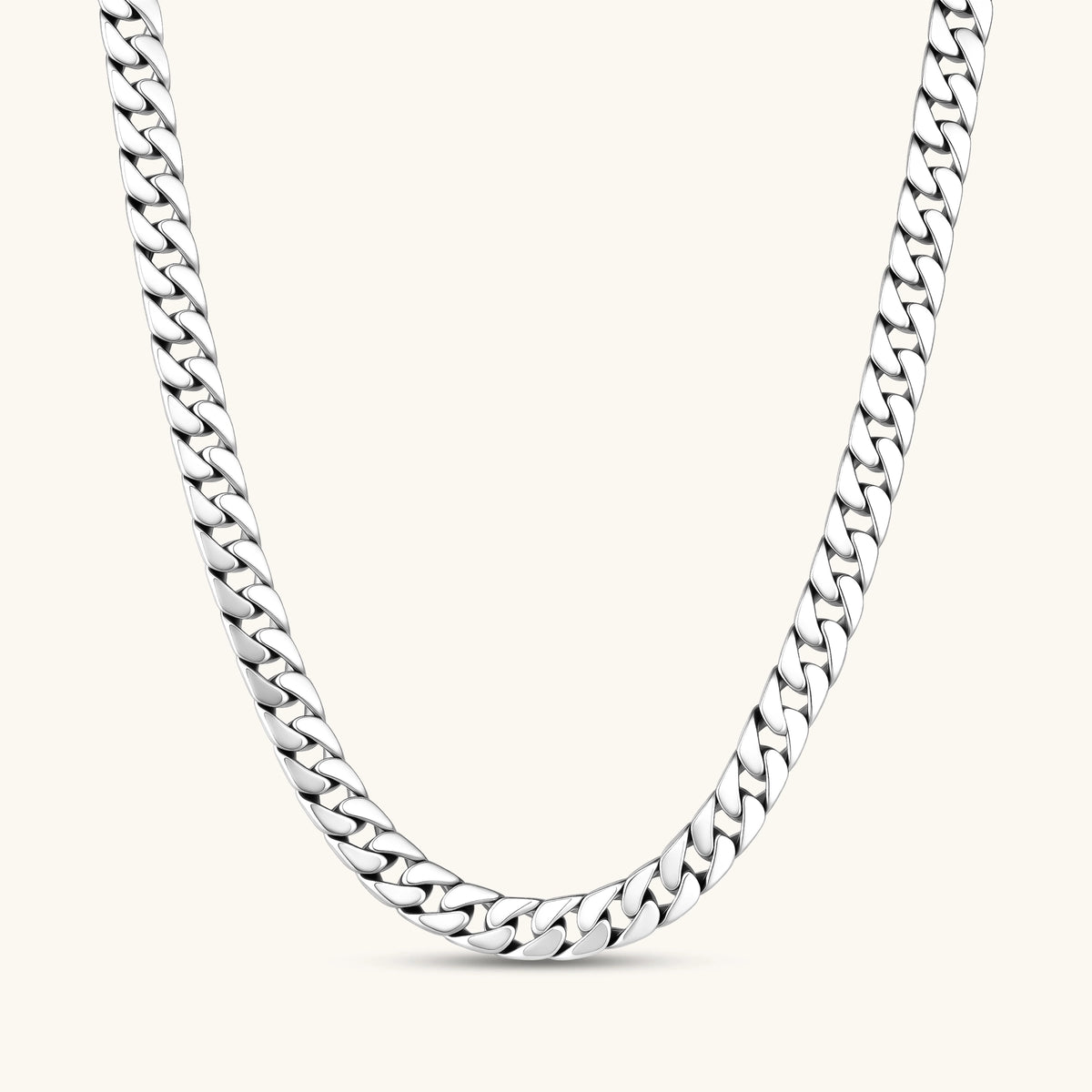 Polished 925 sterling silver Cuban link chain necklace, 550mm length, shown flat and draped on cream background.