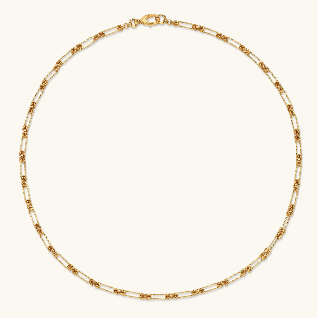 Gold-plated sterling silver chain necklace with alternating love-knot links and elongated oval links, lobster clasp closure.