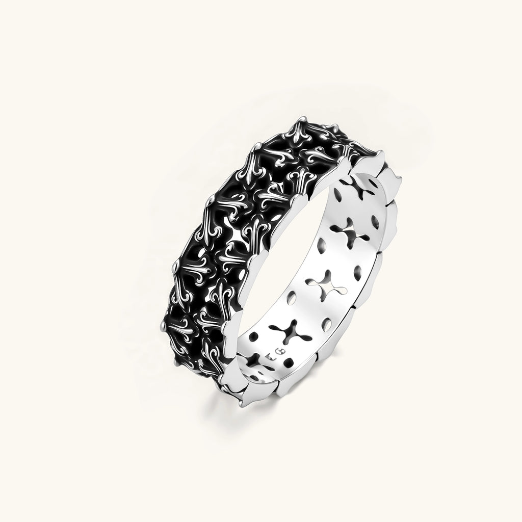 Sterling silver band ring with oxidized black fleur-de-lis cutwork pattern, 6.5mm wide, on white background.