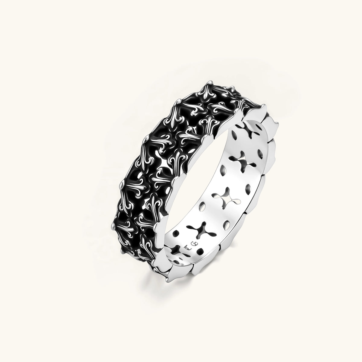 Sterling silver band ring with oxidized black fleur-de-lis cutwork pattern, 6.5mm wide, on white background.