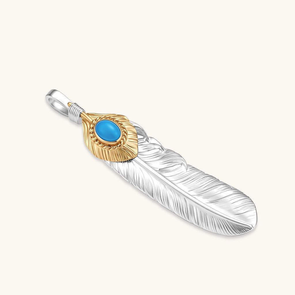 Sterling silver feather pendant with a gold-tone leaf accent and oval blue stone, shown on a box chain against a cream background.