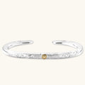Sterling silver open cuff bracelet with scroll engravings, gold central medallion, and eagle-head terminals. 78mm outer diameter.