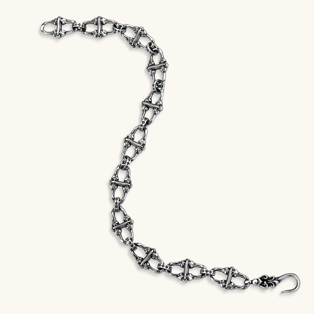 Sterling silver link bracelet with fleur-de-lis cross motifs, oxidized detailing, and hook clasp, 200mm length.