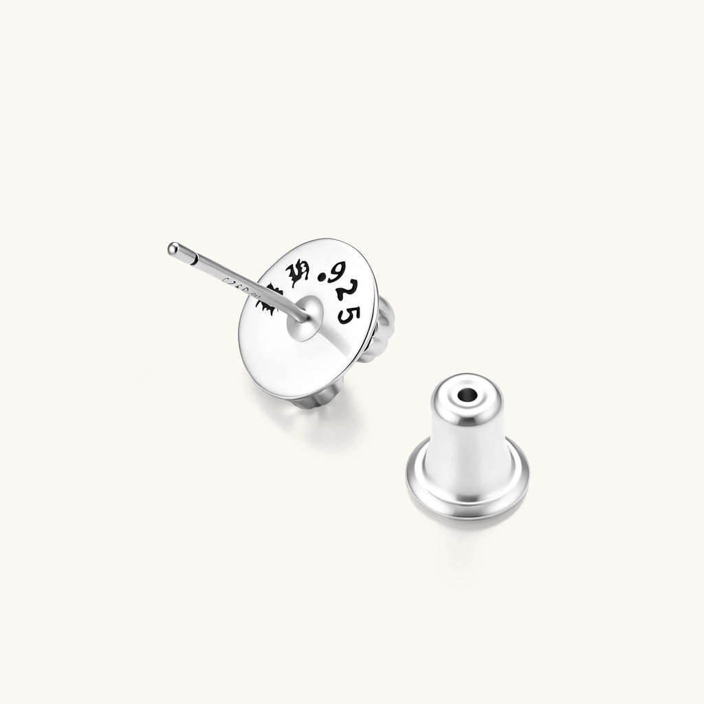 Sterling silver dome stud earring with oxidized black petals, ornate scrollwork, and clear cubic zirconia stones, butterfly back.